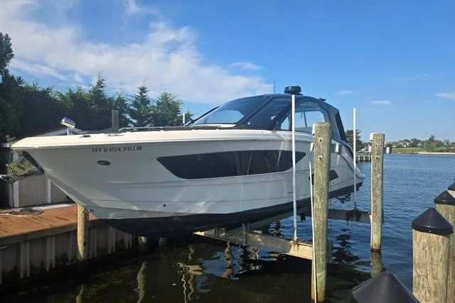 The Image of 2024 Sea Ray Sundancer 370 Outboard docked, showcasing sleek design and modern features. - 0