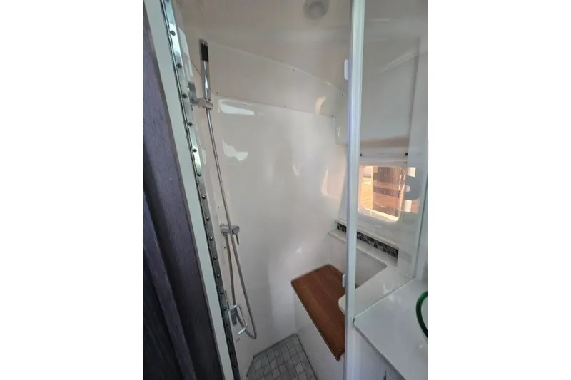 Slide: The Image of 2024 Sea Ray Sundancer 370 Outboard bathroom with shower and window. - 17