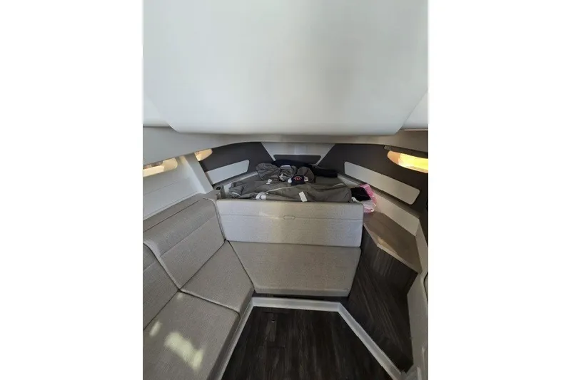 Slide: The Image of Interior cabin of 2024 Sea Ray Sundancer 370 Outboard, featuring modern seating and sleek design. - 14