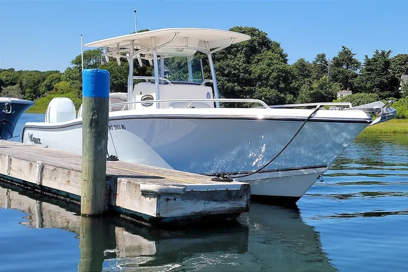 The Image of 2018 Mako 284 Center Console boat docked on a sunny day. - 0