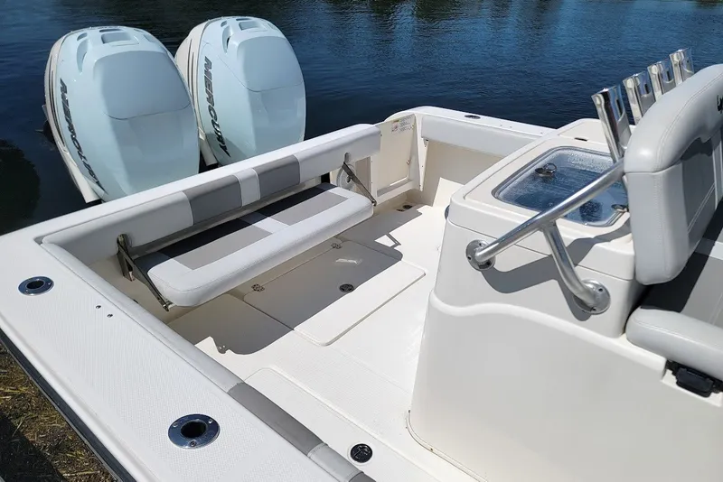 Slide: The Image of 2018 Mako 284 Center Console boat with twin Mercury engines, featuring spacious seating and fishing amenities. - 19