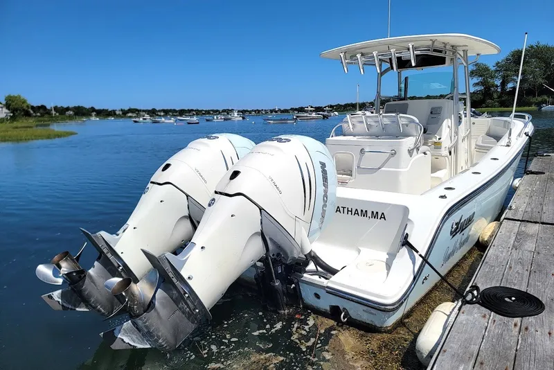 Slide: The Image of 2018 Mako 284 Center Console boat docked with dual Mercury outboard engines. - 17