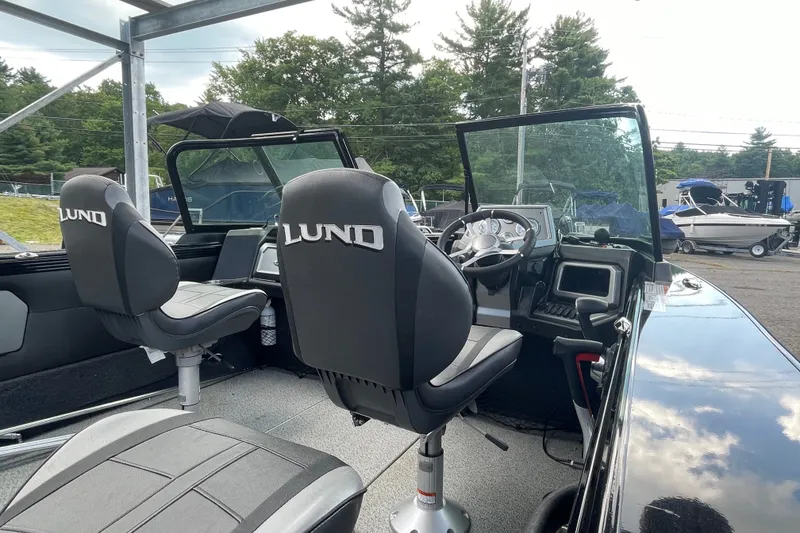 The Image of Interior of 2023 Lund 1975 Tyee boat with steering wheel and branded seats. - 0