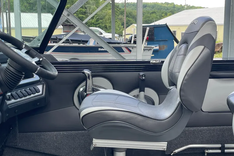 Slide: The Image of Interior of a 2023 Lund 1975 Tyee boat, featuring a sleek steering wheel and comfortable seating. - 3