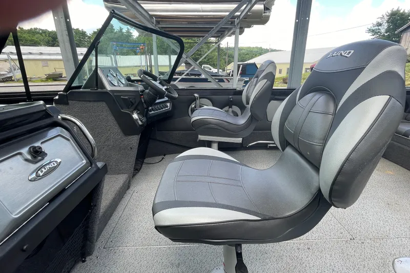 Slide: The Image of Interior of a 2023 Lund 1975 Tyee boat with modern seating and dashboard. - 13