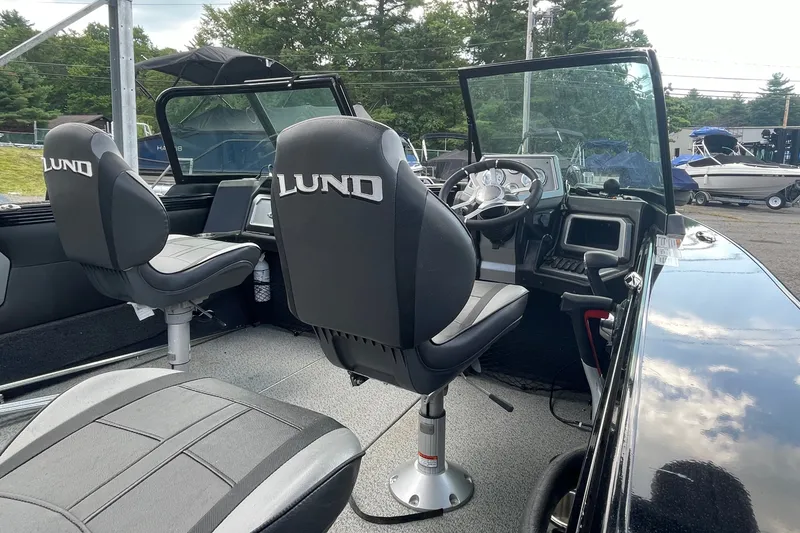Slide: The Image of Interior of 2023 Lund 1975 Tyee boat with steering console and branded seats. - 8
