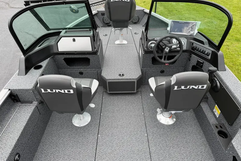Slide: The Image of 2027 Lund 1775 Impact XS Sport boat interior with dual seats and steering console. - 6