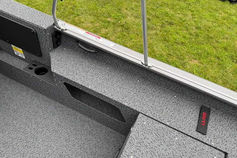 Slide: The Image of Interior of 2027 Lund 1775 Impact XS Sport boat with textured flooring and cup holder. - 17