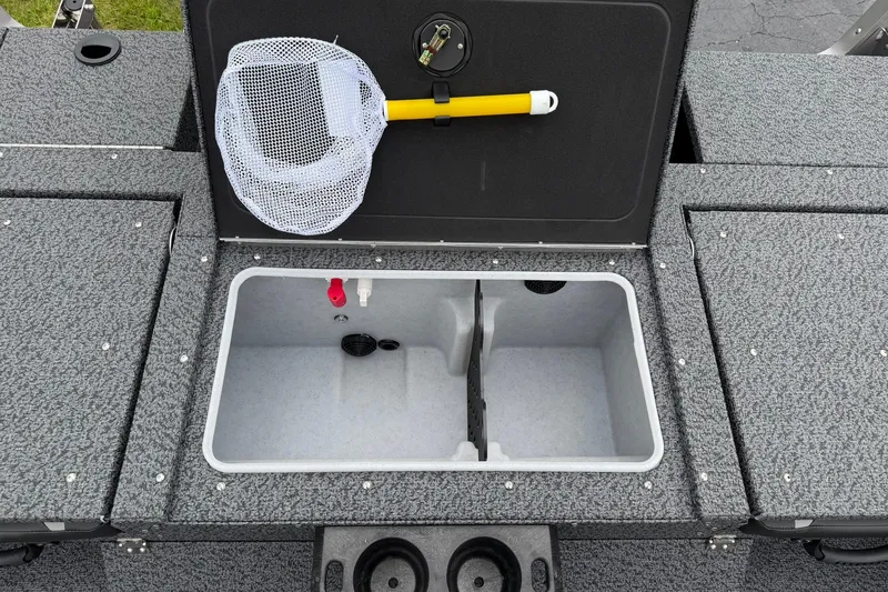 Slide: The Image of 2027 Lund 1775 Impact XS Sport boat interior with storage compartment and fishing net. - 11