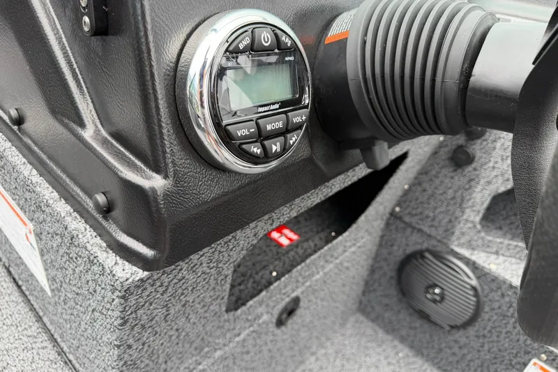 Slide: The Image of Control panel of 2027 Lund 1775 Impact XS Sport boat with audio system and steering. - 24