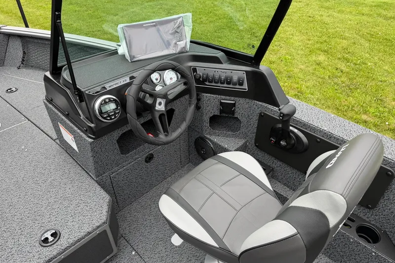 Slide: The Image of 2027 Lund 1775 Impact XS Sport boat cockpit with steering wheel and control panel. - 12