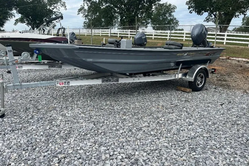 Slide: The Image of 2027 War Eagle 754VS Stick Steer boat on trailer, parked on gravel lot. - 2