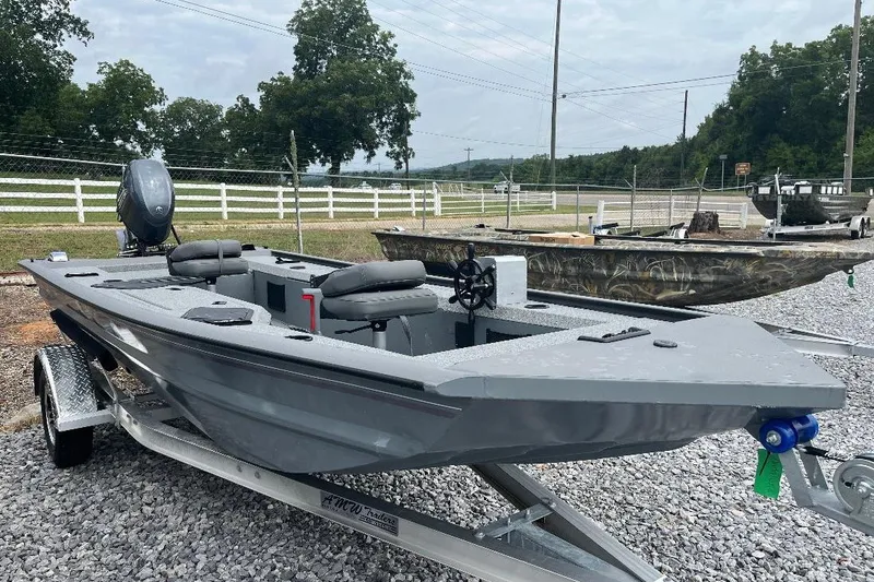 Slide: The Image of 2027 War Eagle 754VS Stick Steer boat on trailer, parked outdoors. - 8