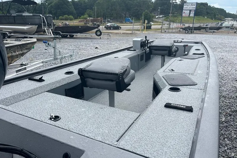 Slide: The Image of 2027 War Eagle 754VS Stick Steer boat with dual seats, parked on gravel lot. - 5