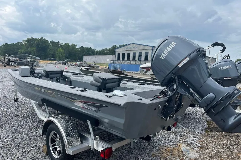 Slide: The Image of 2027 War Eagle 754VS Stick Steer boat with Yamaha motor on trailer, outdoor setting. - 13