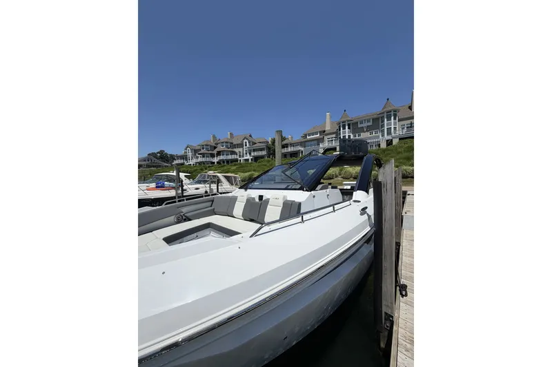 Slide: The Image of 2024 Cruisers Yachts 42 GLS OB docked near luxury waterfront homes. - 4
