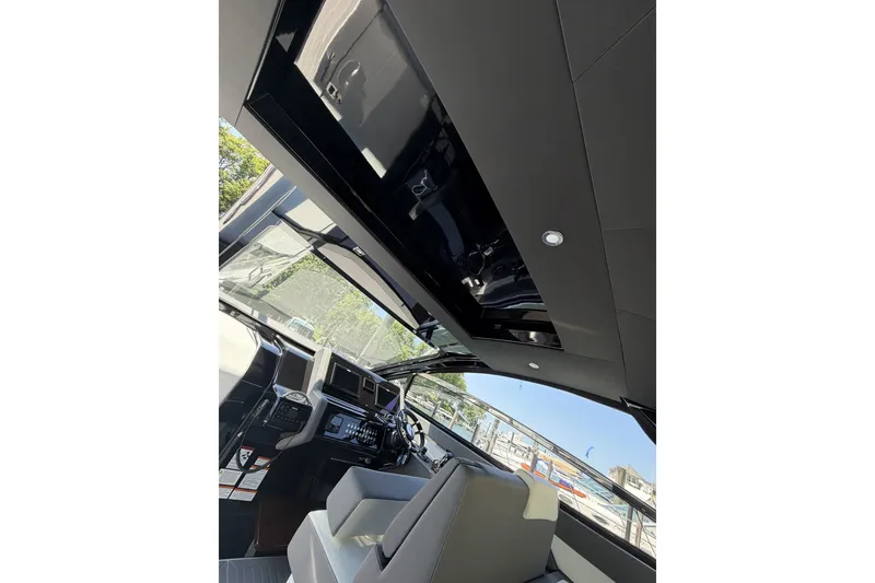 Slide: The Image of Interior view of 2024 Cruisers Yachts 42 GLS OB helm with modern controls and seating. - 14