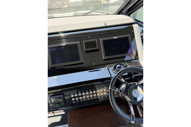 Slide: The Image of Helm of 2024 Cruisers Yachts 42 GLS OB with dual displays and steering wheel. - 13