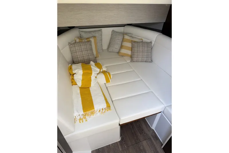 Slide: The Image of Luxurious interior of 2024 Cruisers Yachts 42 GLS OB with cozy seating and decorative pillows. - 21
