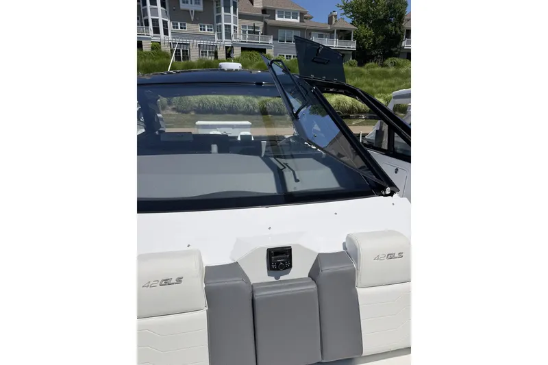 Slide: The Image of 2024 Cruisers Yachts 42 GLS OB boat with sleek windshield and modern seating. - 7