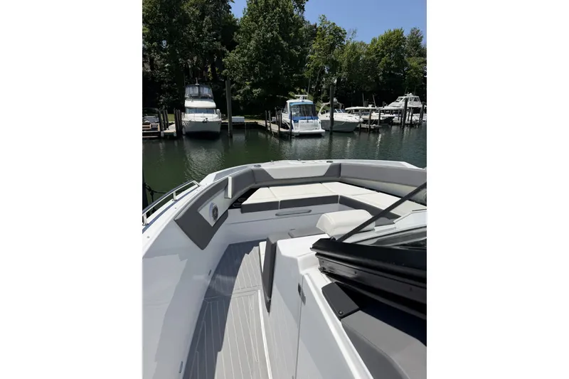 Slide: The Image of 2024 Cruisers Yachts 42 GLS OB at marina, showcasing sleek deck design and seating area. - 11