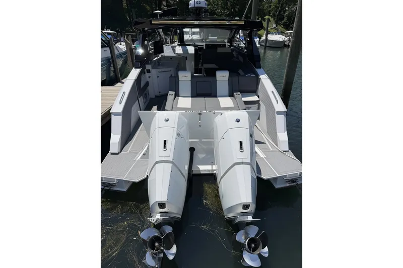 Slide: The Image of 2024 Cruisers Yachts 42 GLS OB with dual outboard engines docked at marina. - 26