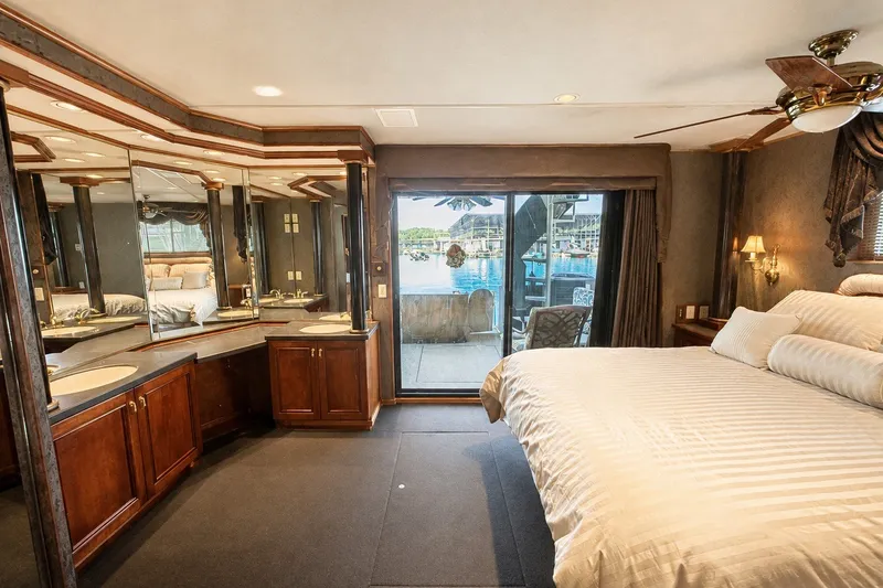 Slide: The Image of Luxurious bedroom in a 1997 Sumerset 16x83 houseboat with lake view and elegant decor. - 10