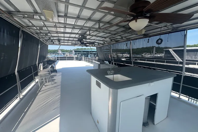 Slide: The Image of Spacious upper deck of 1997 Sumerset 16x83 houseboat with sink and ceiling fan. - 14