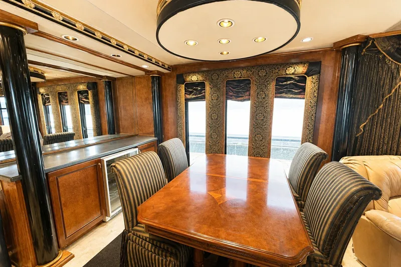 Slide: The Image of Luxurious dining area in a 1997 Sumerset 16x83 houseboat with elegant wood and fabric accents. - 5