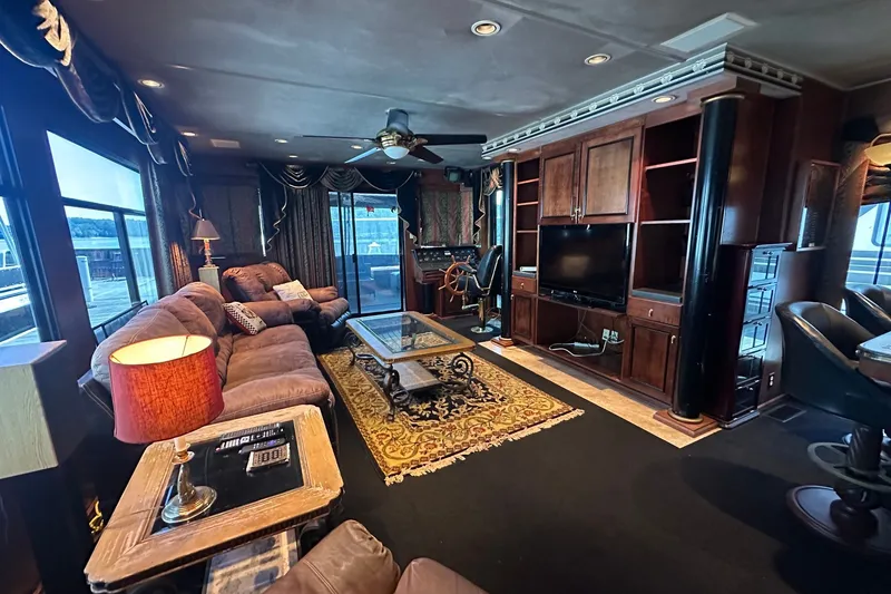 Slide: The Image of Luxurious interior of a 1997 Sumerset 16x83 houseboat with elegant furnishings and entertainment center. - 3