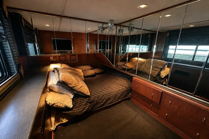 Slide: The Image of Luxurious bedroom interior of a 1997 Sumerset 16x83 houseboat with mirrored walls and cozy bedding. - 7