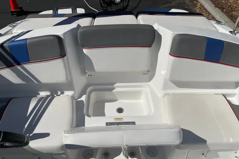 Slide: The Image of 2024 Tahoe T16 boat interior with white and gray seating, blue accents, and storage compartment. - 17