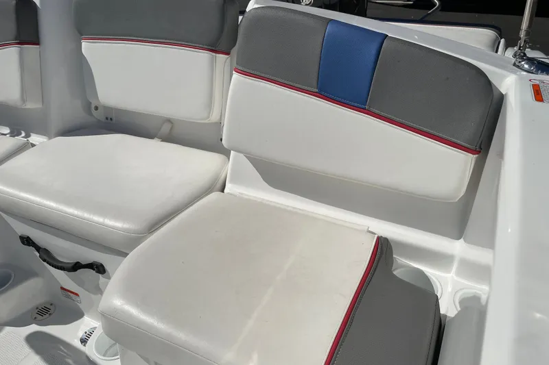 Slide: The Image of 2024 Tahoe T16 boat seating with white, gray, and blue upholstery accents. - 8