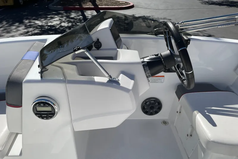 Slide: The Image of 2024 Tahoe T16 boat dashboard with steering wheel and control panel. - 19