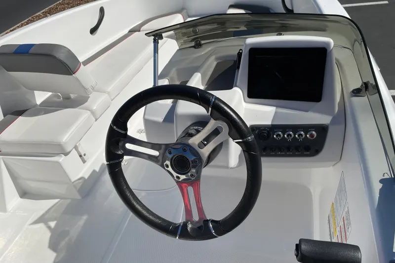 Slide: The Image of 2024 Tahoe T16 boat interior with steering wheel and control panel. - 13