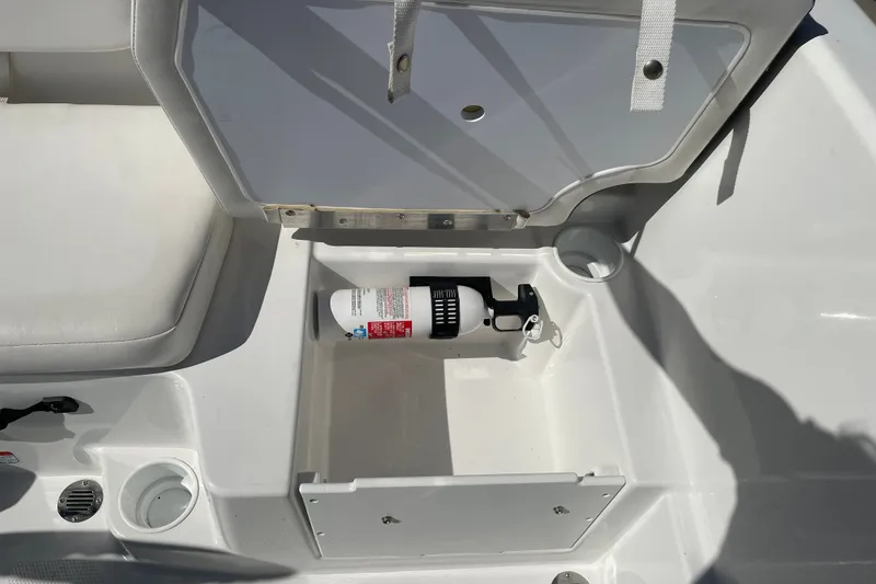 Slide: The Image of Open storage compartment in 2024 Tahoe T16 boat with fire extinguisher inside. - 21