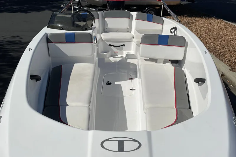 Slide: The Image of 2024 Tahoe T16 boat interior with white and gray seating, featuring red and blue accents. - 4