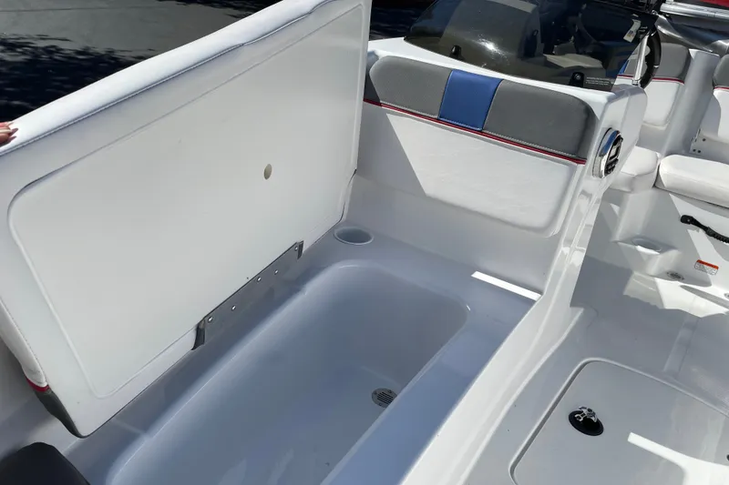 Slide: The Image of 2024 Tahoe T16 boat interior with open storage compartment and seating area. - 6