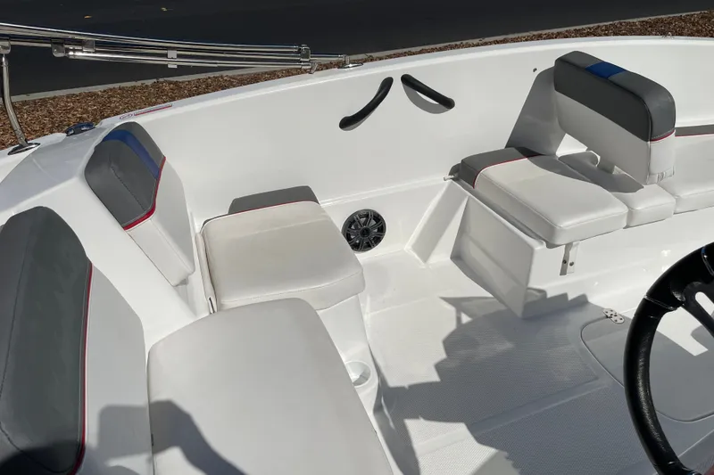 Slide: The Image of 2024 Tahoe T16 boat interior with white and gray seating, featuring red accents and a steering wheel. - 14