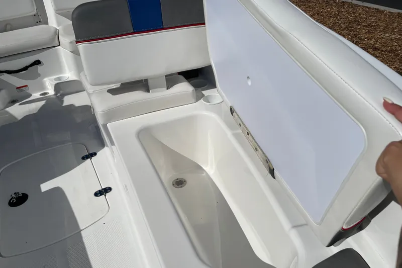 Slide: The Image of 2024 Tahoe T16 boat interior with open storage compartment and seating area. - 7