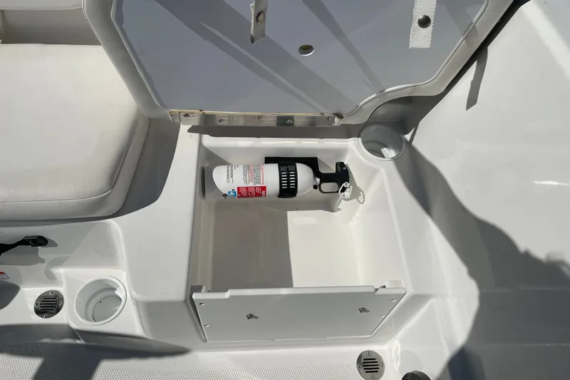 Slide: The Image of 2024 Tahoe T16 boat storage compartment with fire extinguisher and cup holder. - 18