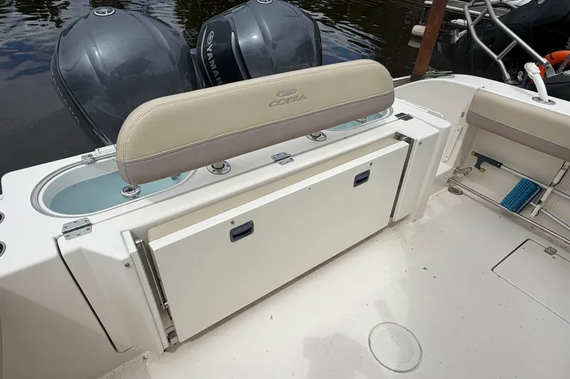 Slide: The Image of 2017 Cobia 296 Center Console boat with Yamaha engines and seating area. - 16