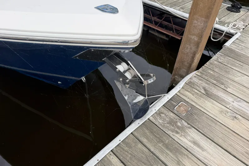 Slide: The Image of 2017 Cobia 296 Center Console boat docked, showing propeller and hull. - 19