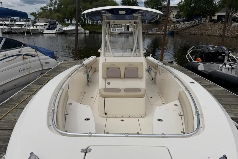 Slide: The Image of 2017 Cobia 296 Center Console boat docked at marina, showcasing spacious deck and seating. - 20
