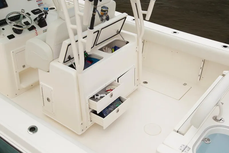 Slide: The Image of Manufacturer Provided Image: 2017 Cobia 296 Center Console boat interior with storage compartments and fishing gear. - 14