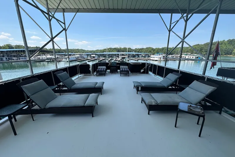 Slide: The Image of Spacious deck of 2003 Sumerset 18x86 houseboat with lounge chairs and scenic marina view. - 23