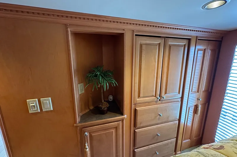 Slide: The Image of Wooden cabinetry in a 2003 Sumerset 18x86 houseboat interior, featuring a small potted plant. - 8