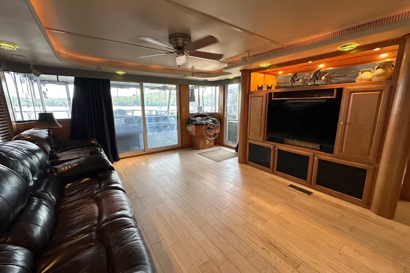 Slide: The Image of Luxurious 2003 Sumerset 18x86 houseboat interior with leather seating and entertainment center. - 3