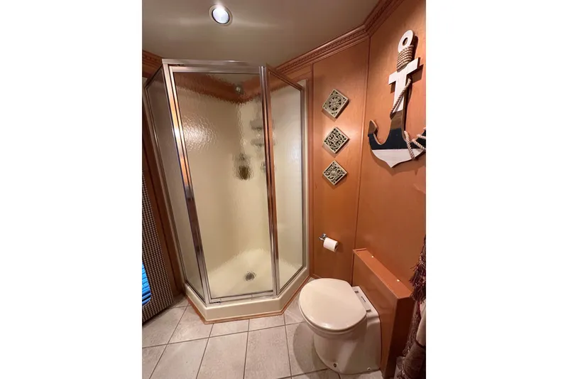 Slide: The Image of Bathroom in 2003 Sumerset 18x86 houseboat with shower, toilet, and nautical decor. - 14