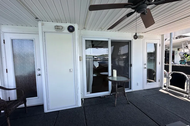 Slide: The Image of Outdoor deck of a 2003 Sumerset 18x86 houseboat with seating and ceiling fan. - 17